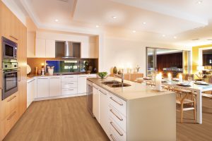 Roomy interior has illuminated with yellow light spreading over the whole kitchen and dining area The flashing candles on the center of the kitchen and top of the table giving an extra shiny look to the area